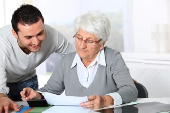 junger Mann Pflegefachkraft mit netter Dame, Seniorenheim, Pflegedienst, Glossar